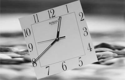 picture of a clock on a rocky field